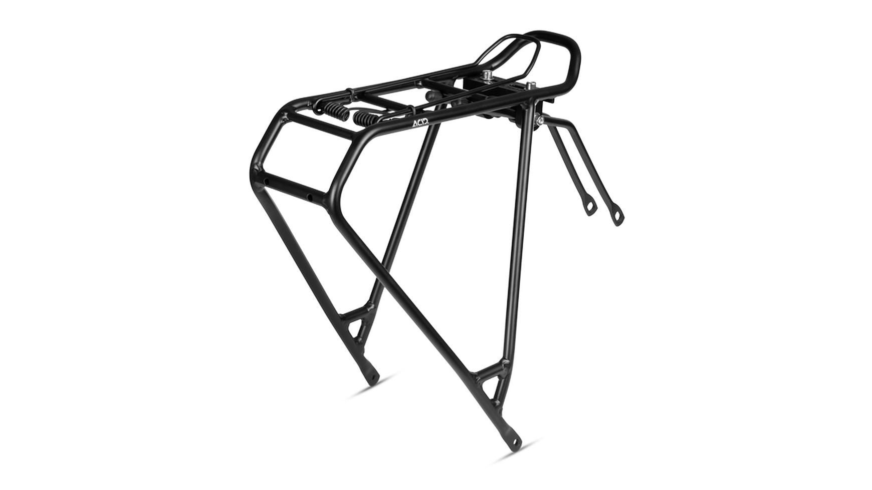 Der ACID Universal Kids RILink 24" ist ein schwarzer Metall-Heckgepäckträger mit seitlichen Stützen und Federklemme, der für die Montage an der Rückseite eines Fahrrads zum Transport von Lasten oder Packtaschen konzipiert ist.
